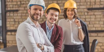 team-of-happy-architects-in-hard-hats-looking-at-c-2021-08-30-19-53-11-utc-1.jpg